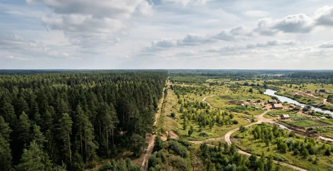 Wide environmental shot showing two distinct landscape zones meeting at a horizon line, representing developed versus emerging market opportunities, captured with extended depth of field in natural light